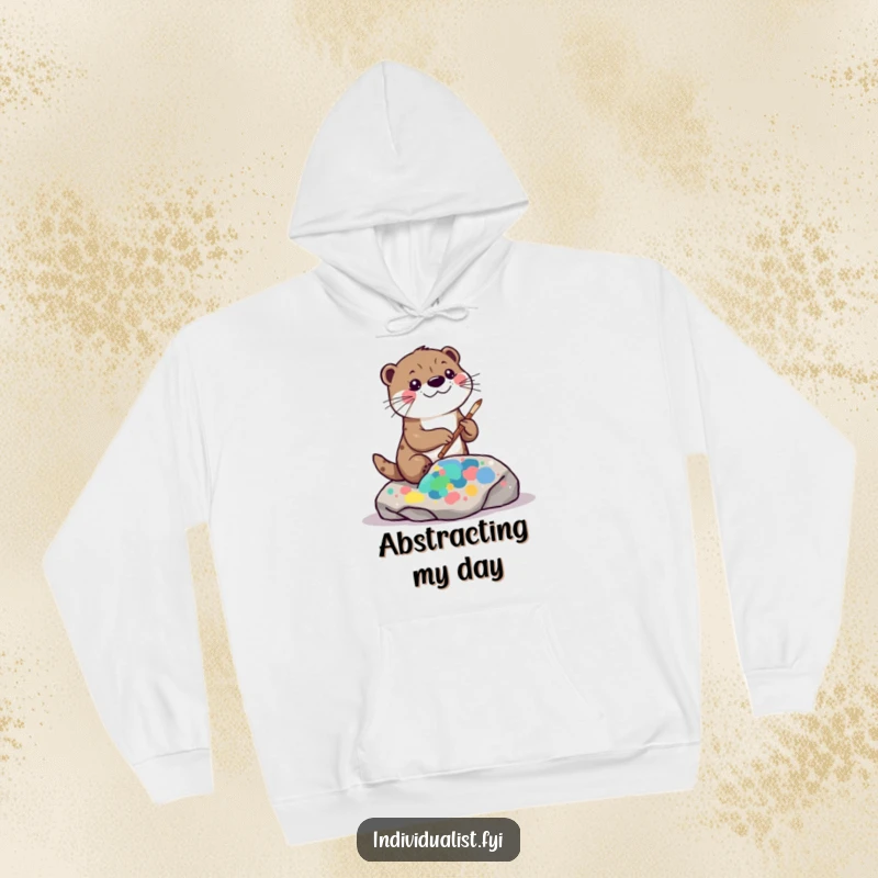 Funny kawaii otter hoodie, showing a playful otter painting a vibrant, abstract pattern on a rock, radiating artistic energy.