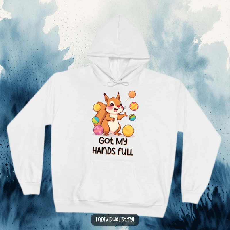 Funny Squirrel Hoodie: An excited squirrel juggles colorful balls while wearing a cozy, playful hoodie.