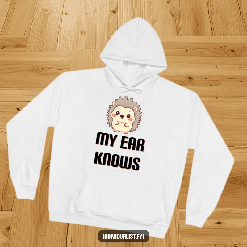 Funny Hedgehog Hoodie featuring a content hedgehog with one ear playfully erect amongst its quills, radiating warmth and humor.
