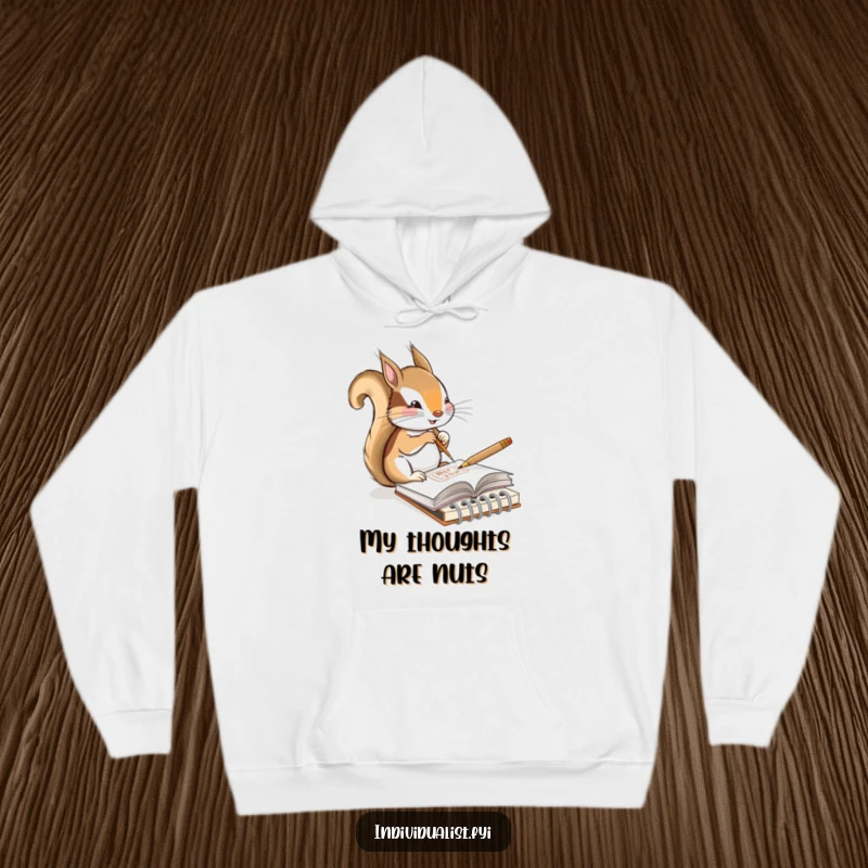 Funny hoodie featuring a content squirrel artist sketching a unique design in a tiny notebook, perfect for cozy creative sessions.
