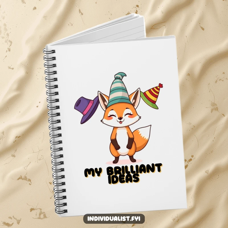 Funny notebook with a spirited fox juggling three different colored, eccentric hats on the cover, inspiring playful note-taking.