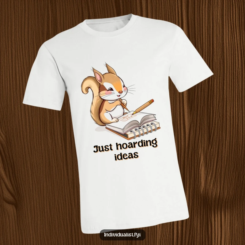 Funny t-shirt showing a content squirrel artist sketching a unique design in a tiny notebook, celebrating creativity and humor.